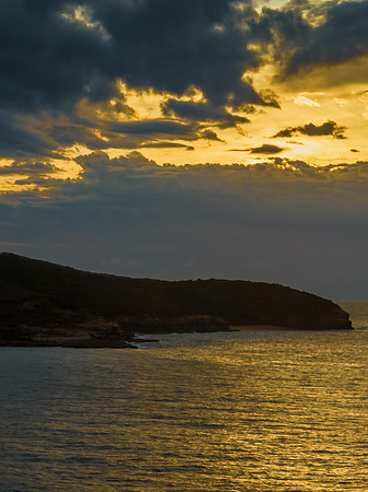 Sunrise seascape with clouds and gentle surf