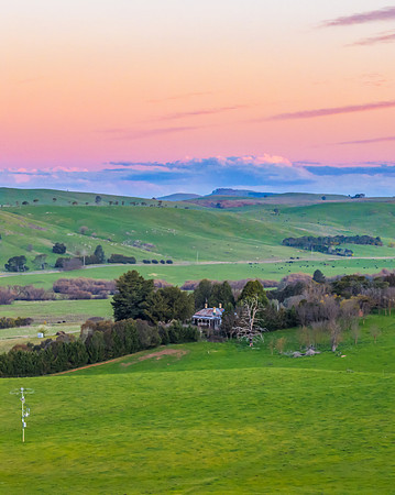 Rural Sunset Landscape with Farm House amongst the Trees