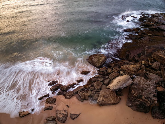 Sunrise views over the beach, sea and rocks