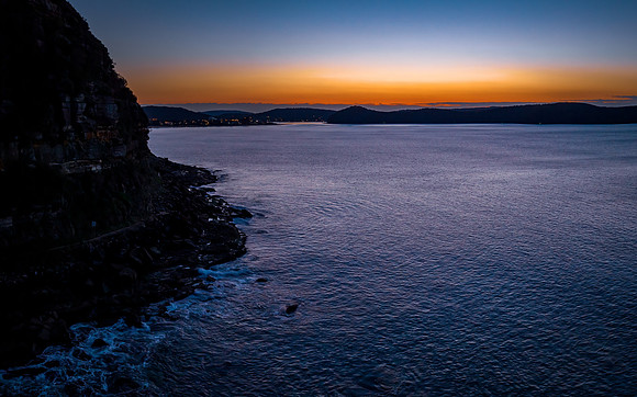 Aerial sunrise over the calm sea and smoke haze clear sky