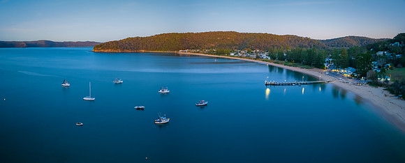 Dawn at the bay with boats and mountain ranges from Patonga
