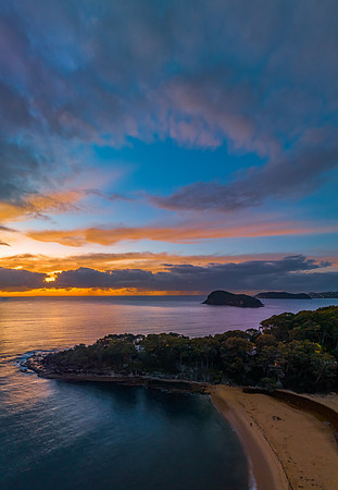 Aerial sunrise seascape with calm seas and a mix of high and low