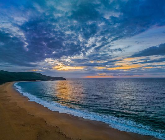 Sunrise seascape with clouds and gentle surf