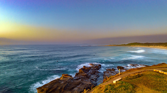 Aerial sunrise seascape with  high tide and rock platform