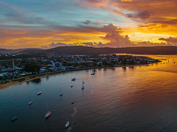Aerial sunrise waterscape with boats, colour and clouds