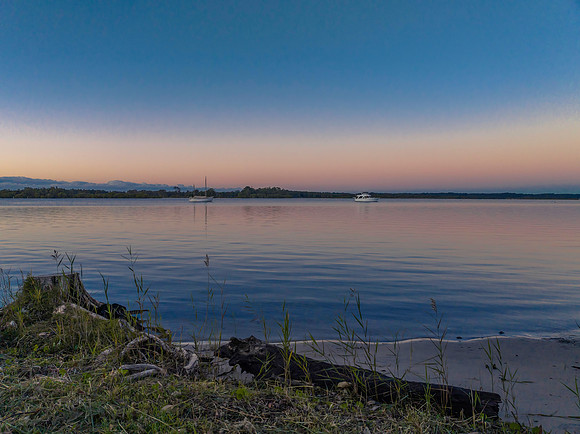 Sunrise over the river with boats