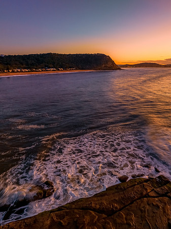 Aerial sunrise over the sea from the headland