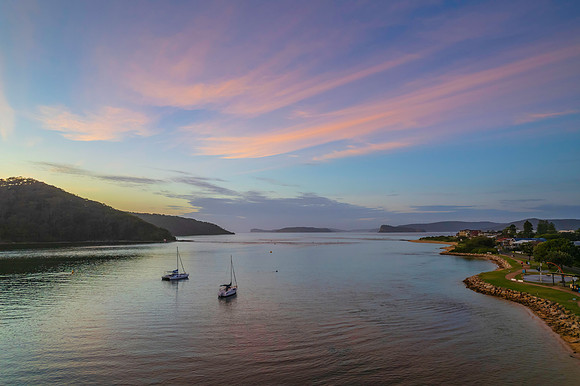 Aerial sunrise waterscape with boats