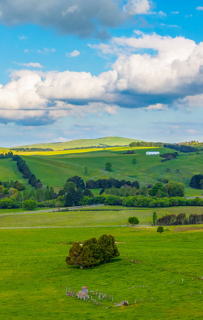 Afternoon aerial views over the green countryside with clouds in