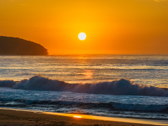 Soft hazy sunrise seascape and orange sky and full sun