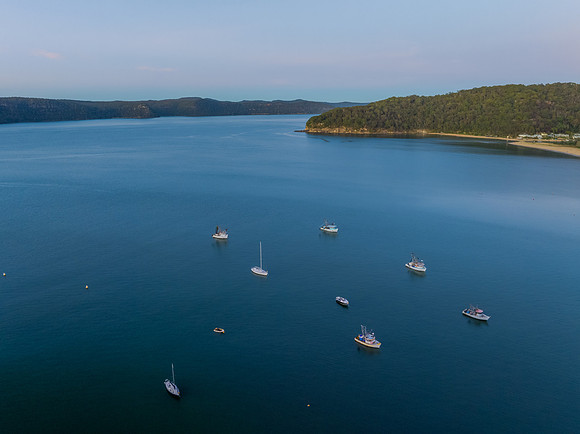 Sunrise views over the bay with boats and mountain ranges from P