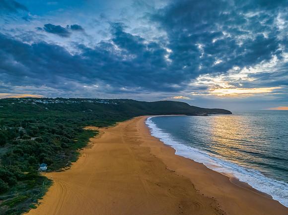 Sunrise seascape with clouds and gentle surf