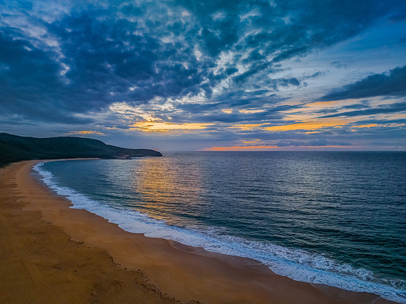Sunrise seascape with clouds and gentle surf