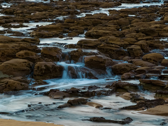 Sunrise and cascades over the rock platform