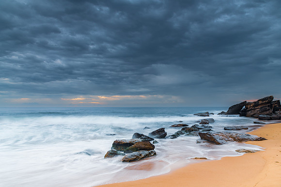 Sunrise at the seaside with rocks and beautiful diffused light b