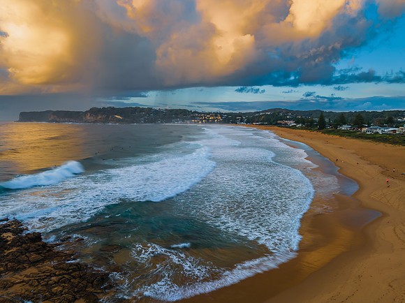 Sunrise and clouds over the ocean and rock platform