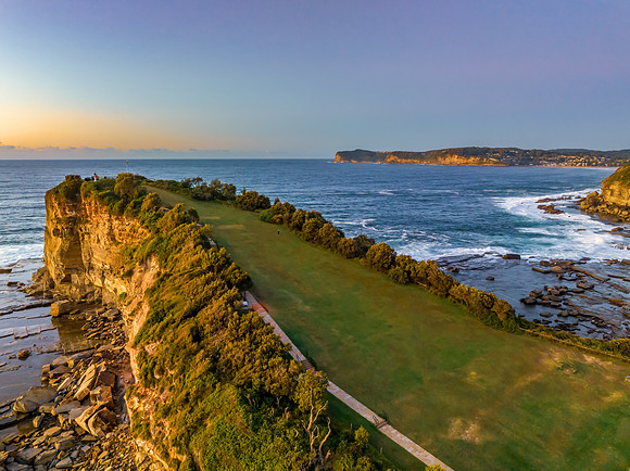 Sunrise over the sea and rocky Inlet with clear skies and a low