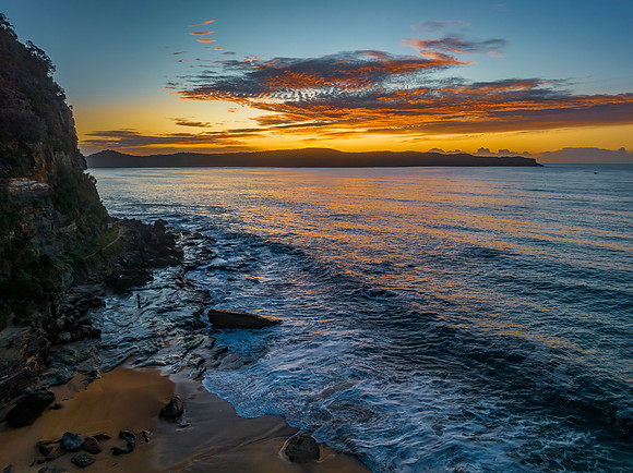 Aerial sunrise seascape with high cloud