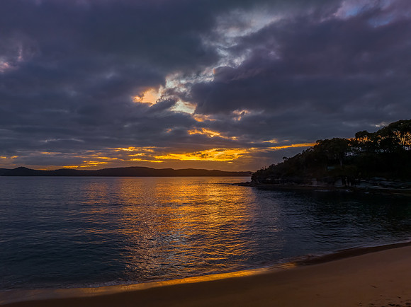 Aerial sunrise seascape with calm seas and a mix of high and low