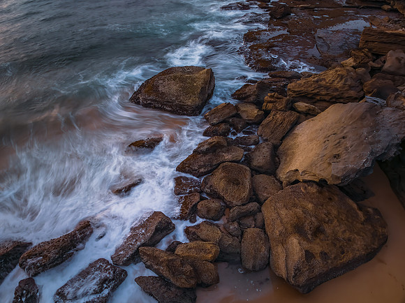 Sunrise views over the beach, sea and rocks