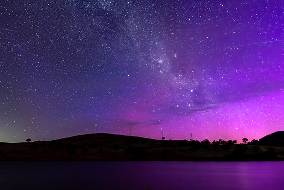 A Pink Aurora Australis and the Milky Way Shimmers Over the Dam