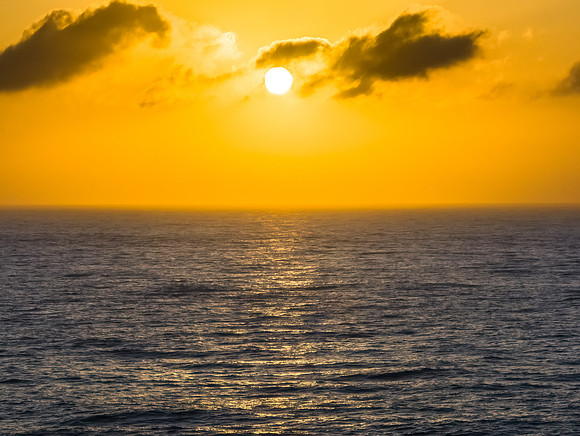Aerial sunrise seascape with the sun, high tide and rock platfor