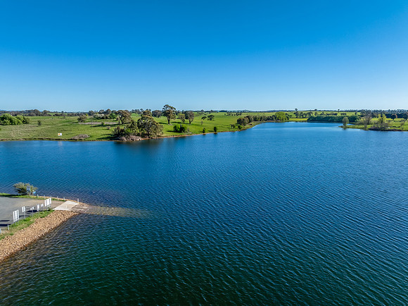 Aerial scenic views over Carcoar Dam with blue sky