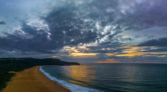 Sunrise seascape with clouds and gentle surf