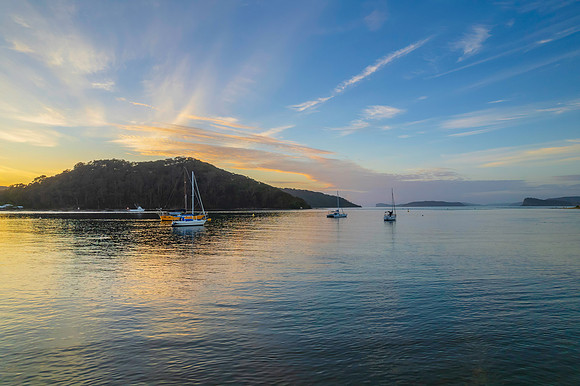 Aerial sunrise waterscape with boats