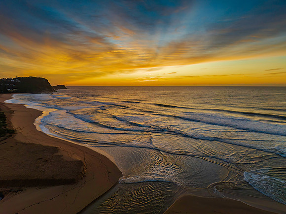 Sunrise and high cloud cover by the sea and lagoon