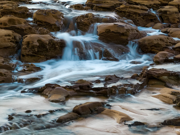 Sunrise and cascades over the rock platform