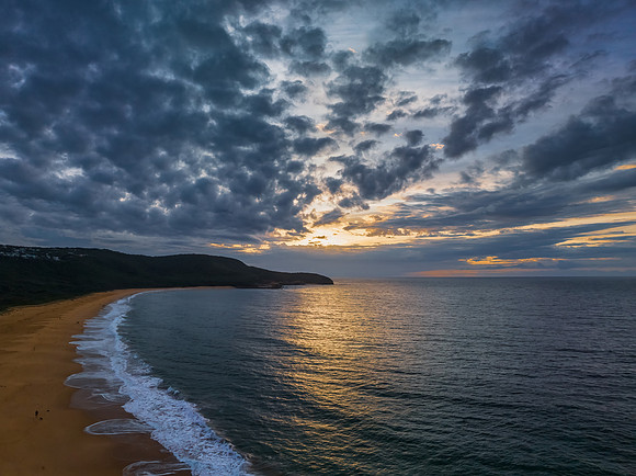 Sunrise seascape with clouds and gentle surf