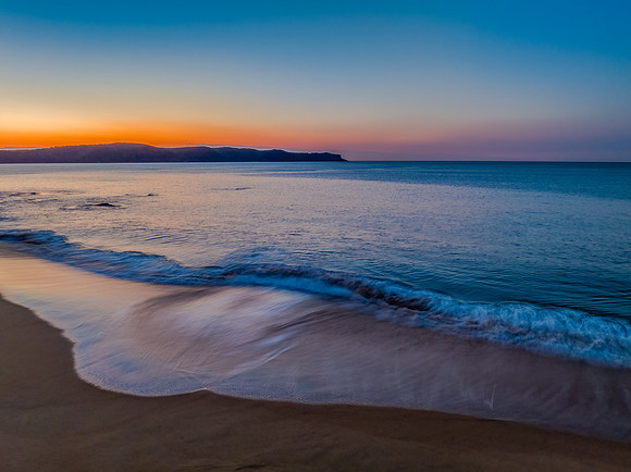 Aerial sunrise over the calm sea and smoke haze clear sky