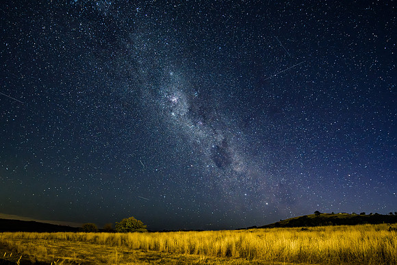 The night sky and Milky Way Galaxy with satellites