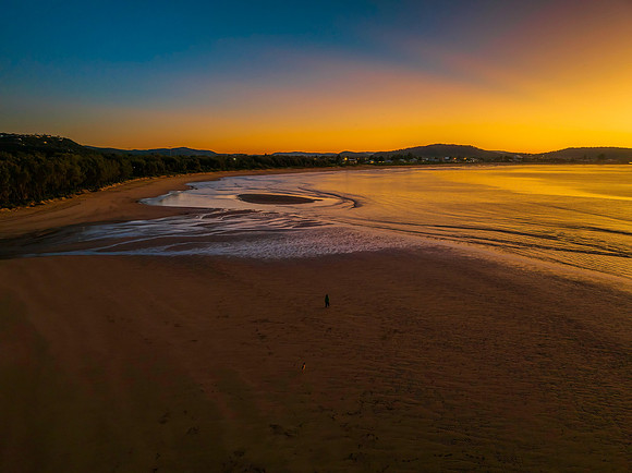 Aerial sunrise seascape with orange glow on a cold Winter's morn