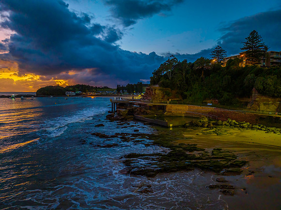 Aerial sunrise at the seaside with rain clouds