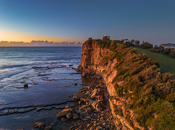 Sunrise over the sea and rocky Inlet with clear skies and a low