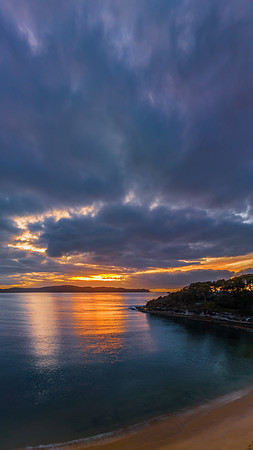 Aerial sunrise seascape with calm seas and a mix of high and low