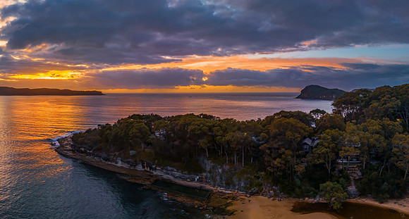 Aerial sunrise seascape with calm seas and a mix of high and low