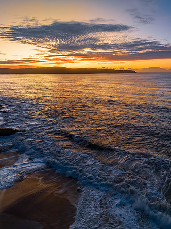 Aerial sunrise seascape with high cloud