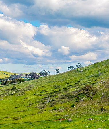 Afternoon aerial views over the green countryside with clouds in