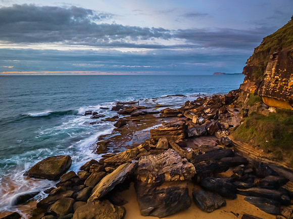 Sunrise seascape with clouds and gentle surf