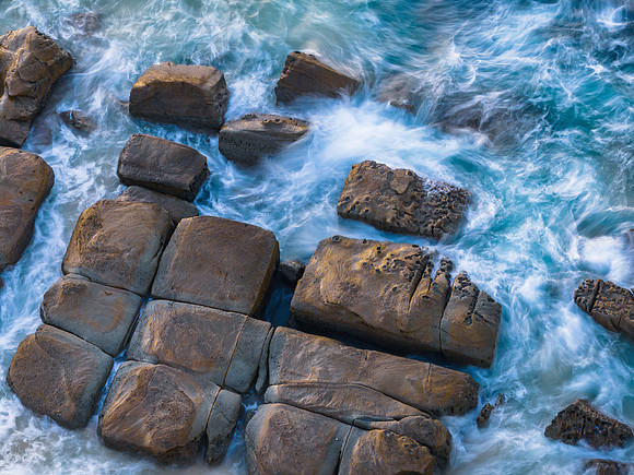 Aerial sunrise seascape with  high tide and rock platform