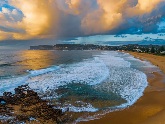 Sunrise and clouds over the ocean and rock platform