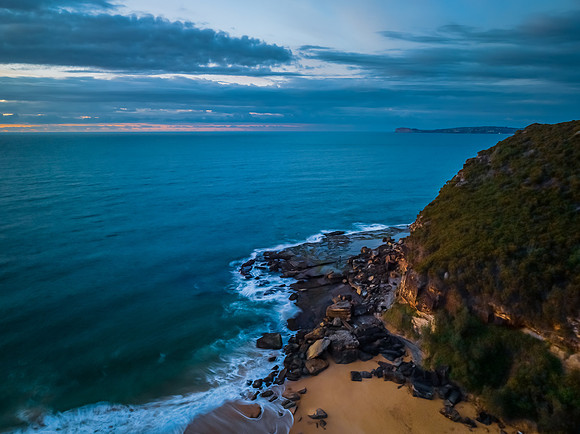 Sunrise seascape with clouds and gentle surf