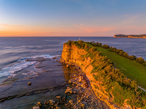 Sunrise over the calm sea and rocky Inlet