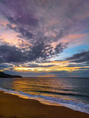 Sunrise seascape with clouds and gentle surf