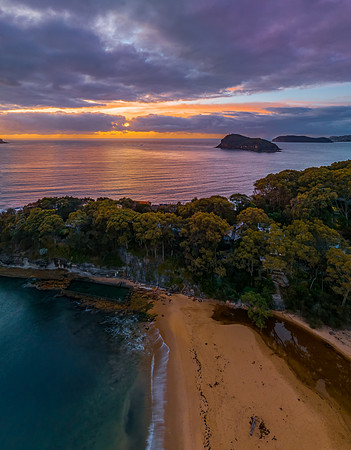 Aerial sunrise seascape with calm seas and a mix of high and low