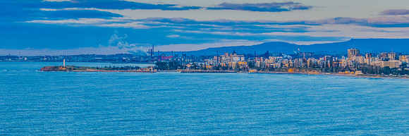 Sunrise seascape panorama with city skyline