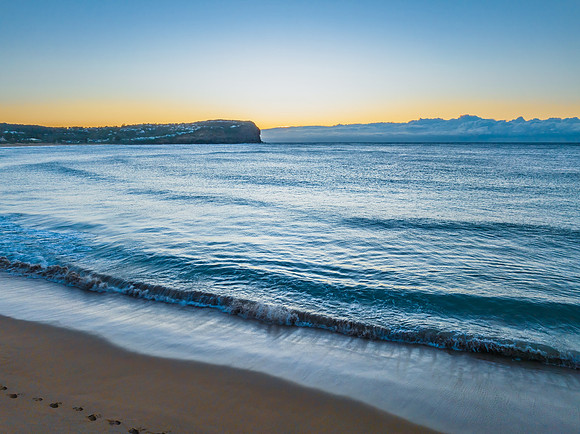 Sunrise over the ocean with low cloud bank